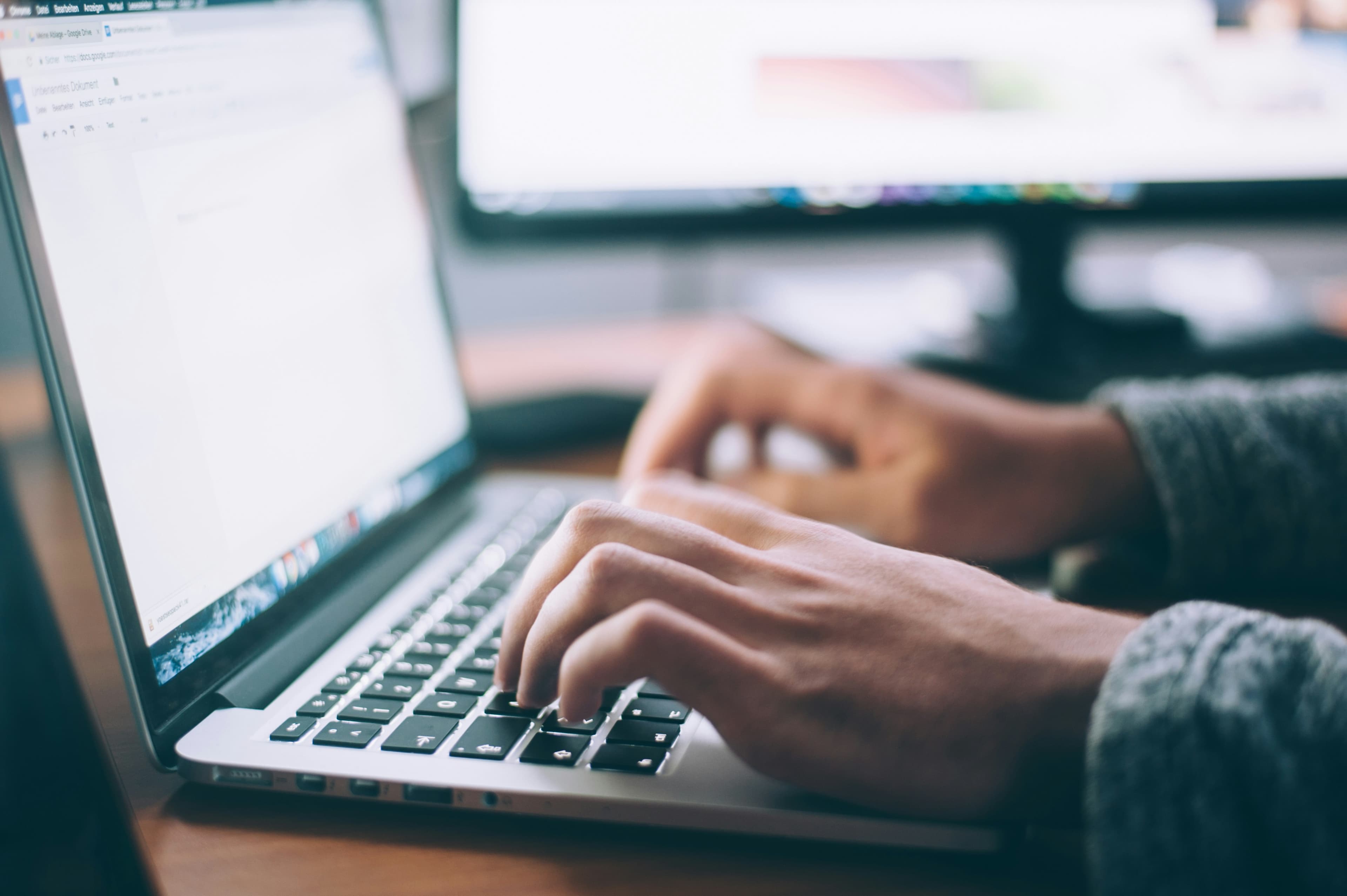 Person working on a laptop at a clean desk